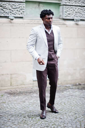 Thoughtful young handsome african american gentleman in formalwear. Black stylish model man in white...