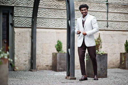 Thoughtful young handsome african american gentleman in formalwear. Black stylish model man in white...
