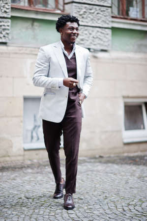 Thoughtful young handsome african american gentleman in formalwear. Black stylish model man in white...