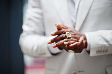 Close up hands with rings of handsome african american gentleman in formalwear.