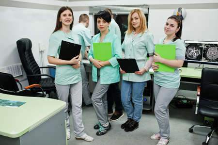 Medical theme.Observation room with a computer tomograph. The group of doctors meeting in the mri...
