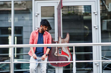 Portrait of young stylish indian man model pose in street.