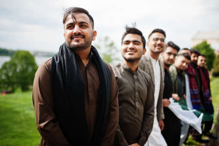 Group of pakistani man wearing traditional clothes salwar kameez or kurta with Pakistan flags.の写真素材