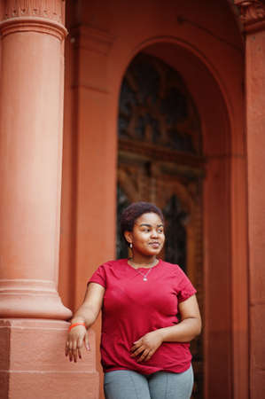 African woman wear red t-shirt posing outdoor.の写真素材