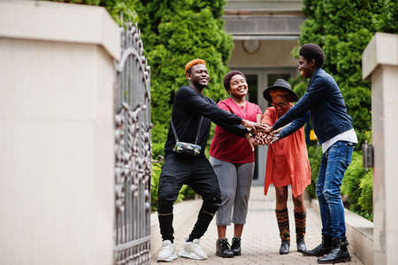 Four african friends having fun outdoors. Two black girls with guys.