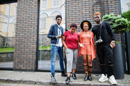 Four african friends having fun outdoors. Two black girls with guys.の写真素材