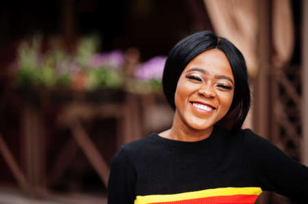 African American woman with bright make-up posing outdoor.の写真素材