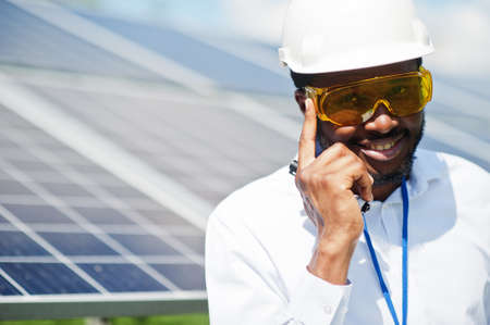 African american technician check the maintenance of the solar panels. Black man engineer at solar...