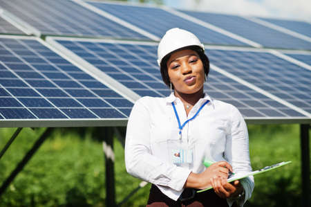 African american technician check the maintenance of the solar panels. Black woman engineer at solar...