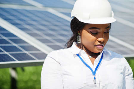 African american technician check the maintenance of the solar panels. Black woman engineer at solar station.の写真素材