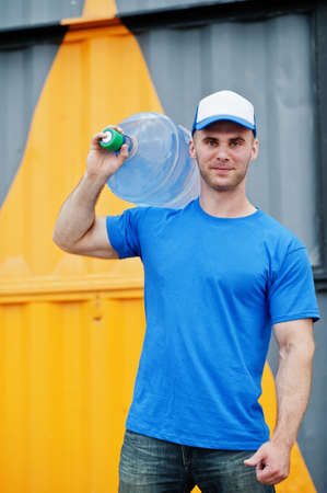 Delivery man carrying water bottle on shoulder.の写真素材