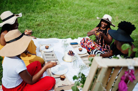 Group of african american girls celebrating birthday party and clinking glasses outdoor with decor.の写真素材