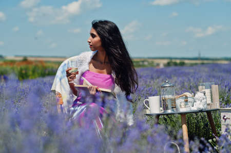 Beautiful indian girl wear saree india traditional dress sitting in purple lavender field with decor.の写真素材