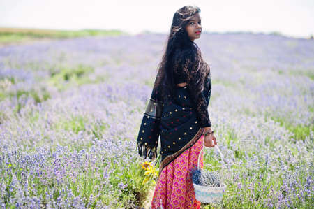 Beautiful indian girl wear saree india traditional dress in purple lavender field.
