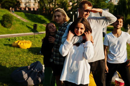 Young multi ethnic group of people in open air cinema.
