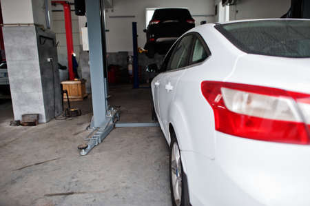 Ð¡ar in maintenance at garage service station.
