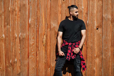 Arab hipster beard man lumberjack against wooden background.