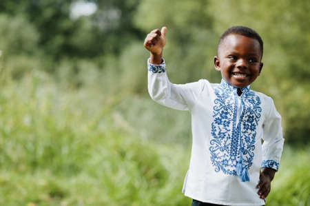 Portrait of african boy kid in traditional clothes at park.の写真素材