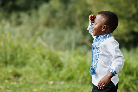 Portrait of african boy kid in traditional clothes at park.の写真素材