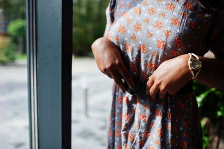 Close up hands with watches of fashion portrait african american woman in long dress.の写真素材