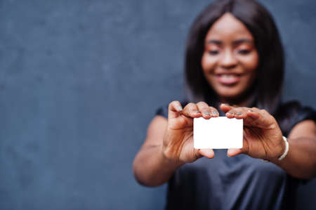 African woman hold empty card in hands.の写真素材