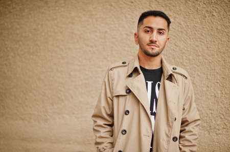 Stylish kuwaiti man at trench coat.