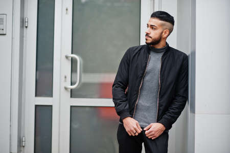 Portrait of stylish arab beard man wear gray turtleneck and black jaket. Arabian model guy.