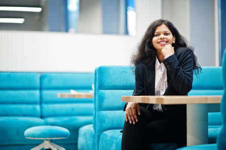 Gorgeous indian woman wear formal posing at cafe.
