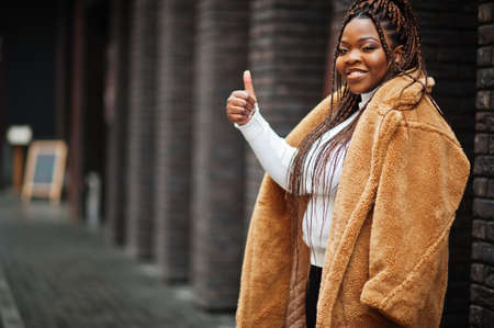 Glamorous african american woman in warm fur coat pose at street.の写真素材