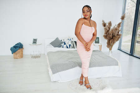 Fashionable photo of young beautiful romantic african american woman with perfect makeup, wearing pink dress. Summer, spring style.の写真素材