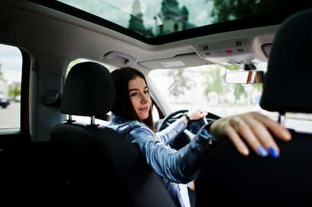 Gorgeous woman sitting inside car interior.