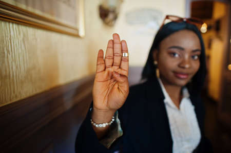 Young deaf mute african american woman using sign language.