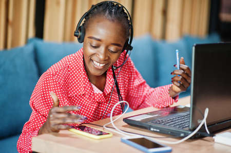 African american woman works in a call center operator and customer service agent wearing microphone...