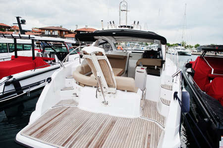 Marine parking of modern motor boats. Luxury yachts docked in sea port.