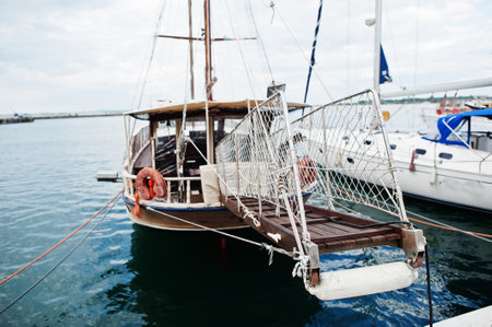 Wooden old sailing ship stay on dock.の写真素材