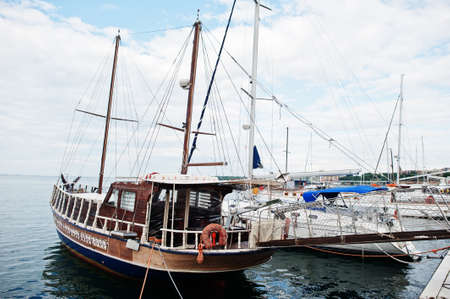 Wooden old sailing ship stay on dock.