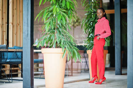 Pretty braids business african american lady bright bossy person friendly wear office red shirt and trousers.の写真素材
