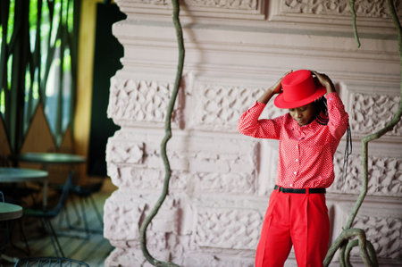 Pretty braids business african american lady bright bossy person friendly wear office red shirt, hat and trousers.の写真素材
