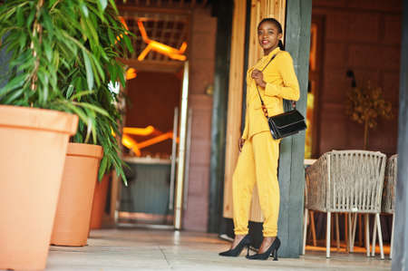 Portrait of nice-looking fashionable attractive lovely content cheerful cheery african american girl wear bright vivid shine vibrant yellow color jacket or costume.の写真素材