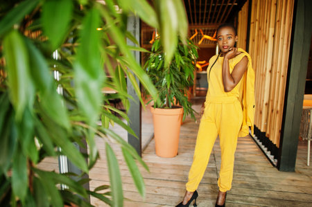 Portrait of nice-looking fashionable attractive lovely content cheerful cheery african american girl wear bright vivid shine vibrant yellow color jacket or costume.の写真素材