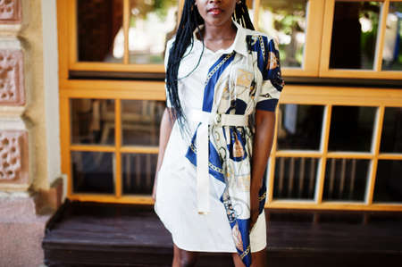 Portrait of a beautiful natural young African woman with afro hair in dress.