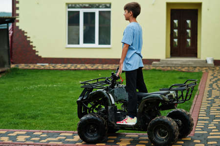 Boy in four-wheller ATV quad bike.の写真素材