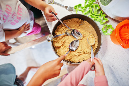 Kids cooking at kitchen, happy children's moments. They preparing cheesecake.の写真素材