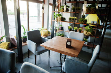 Chairs and table in modern cafe interior.