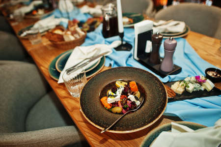 Beautifully laid tables with food, glasses and appliances in restaurant.の写真素材