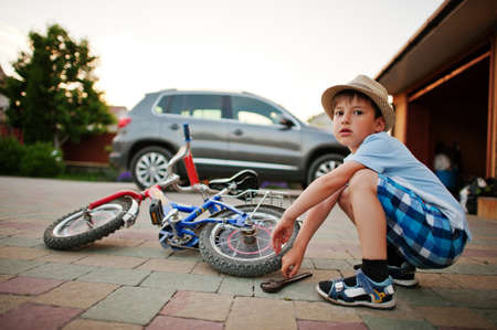 Boy repair bike. Little mechanic work with bicycle.の写真素材