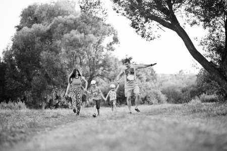Happy young family: mother, father, two children son on nature having fun.の写真素材