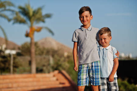 Two brothers on Turkey resort against palms.の写真素材
