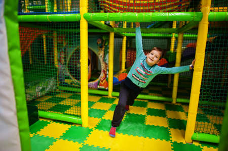 Cute boy playing in indoor play center.