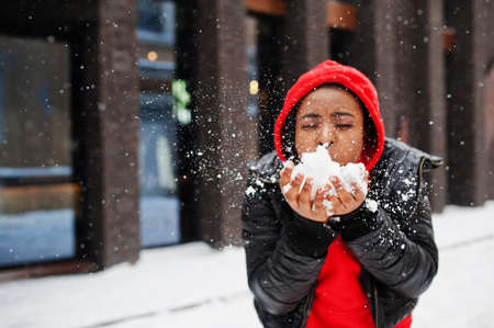 African american woman in red hoodie enjoy winter day.の写真素材